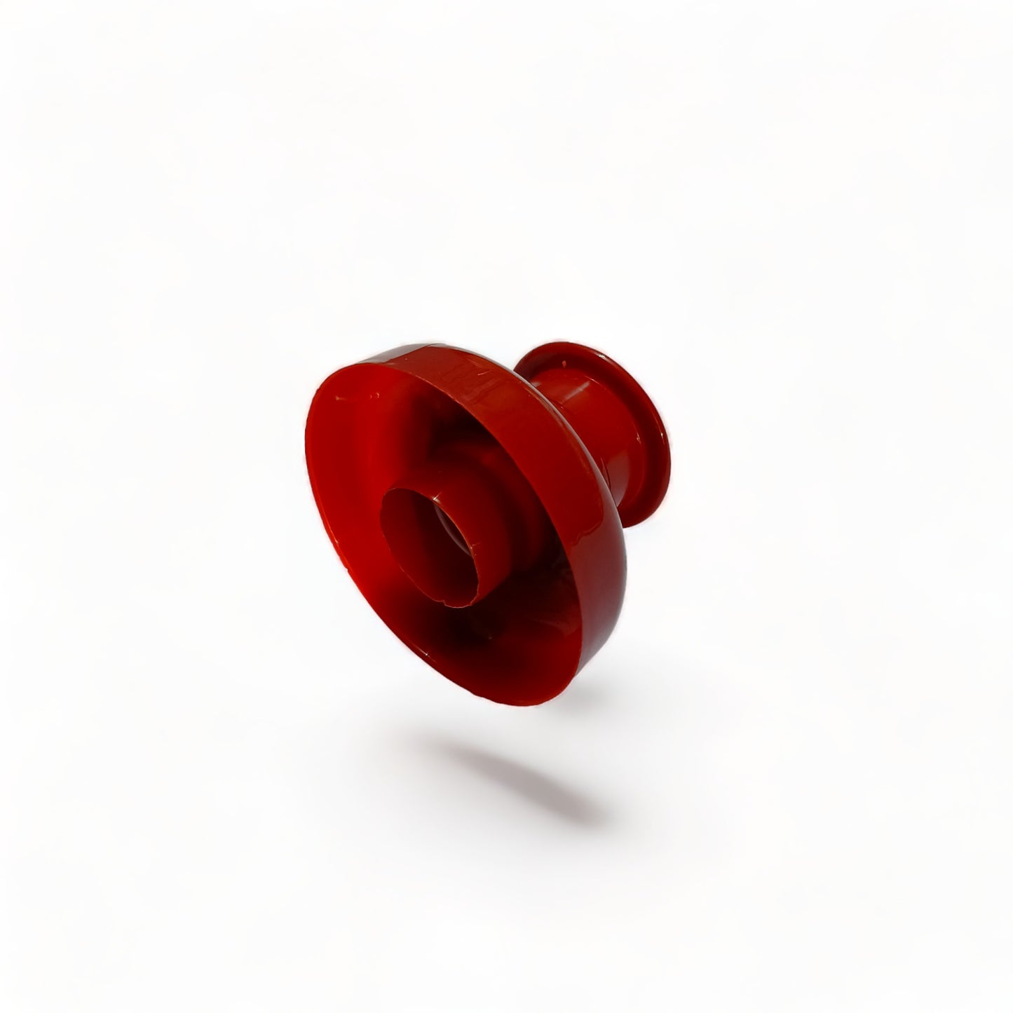 a red frisbee sitting on top of a white surface 