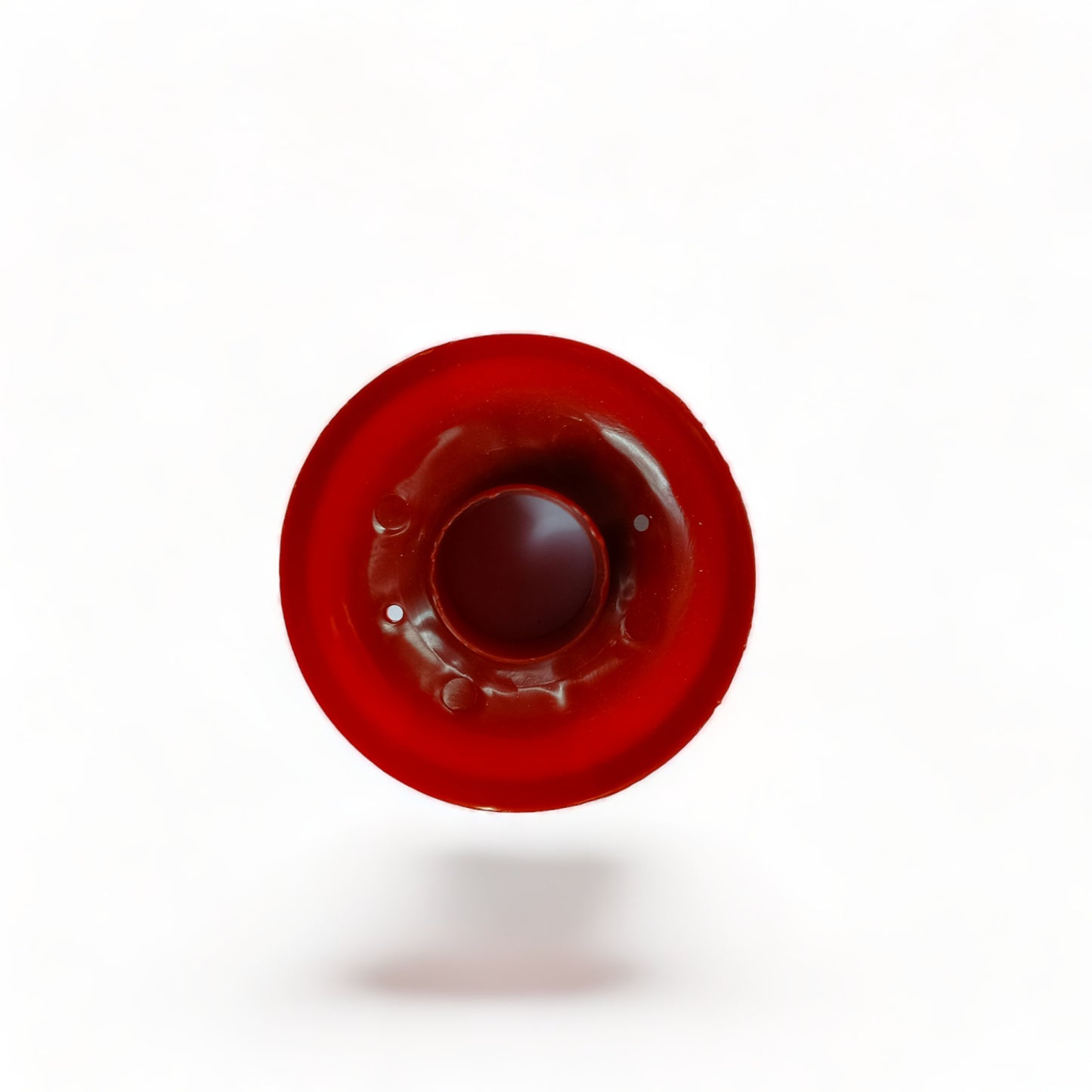 a red frisbee sitting on top of a white surface 